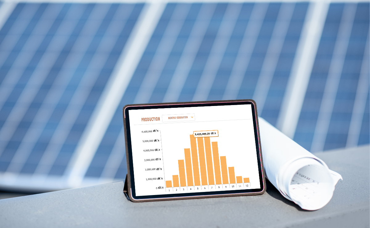 A solar array with an ipad in front displaying a graph.