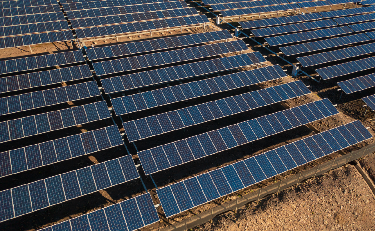 A solar farm on brown soil.