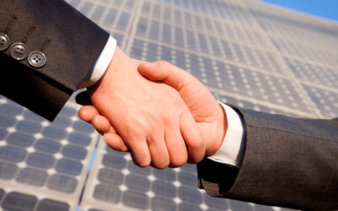 handshake over solar panels